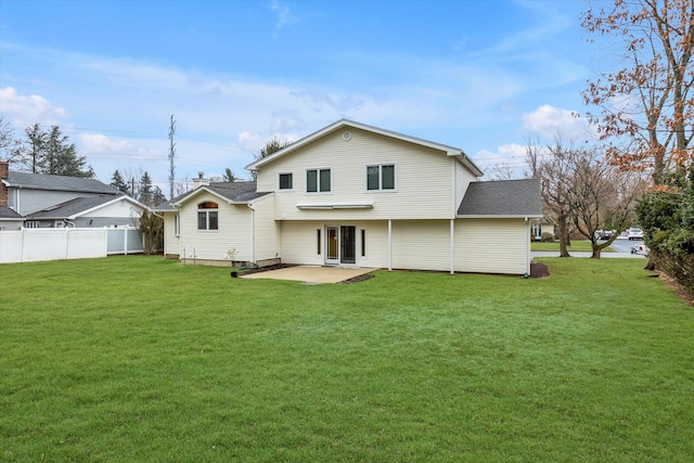 rear view of property featuring a yard and a patio area