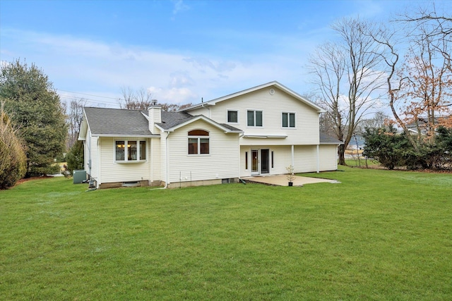 rear view of property featuring a yard, central AC, and a patio area