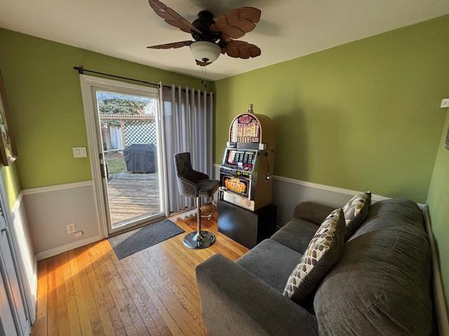 living room featuring hardwood / wood-style floors and ceiling fan