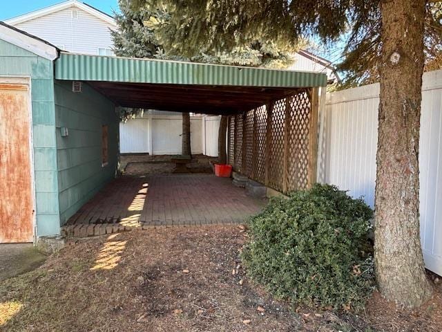 view of vehicle parking with a carport