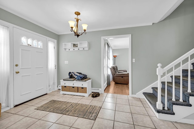 tiled foyer entrance with a notable chandelier, baseboard heating, ornamental molding, baseboards, and stairs