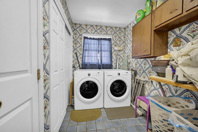 laundry area featuring separate washer and dryer, tile patterned flooring, cabinet space, and wallpapered walls