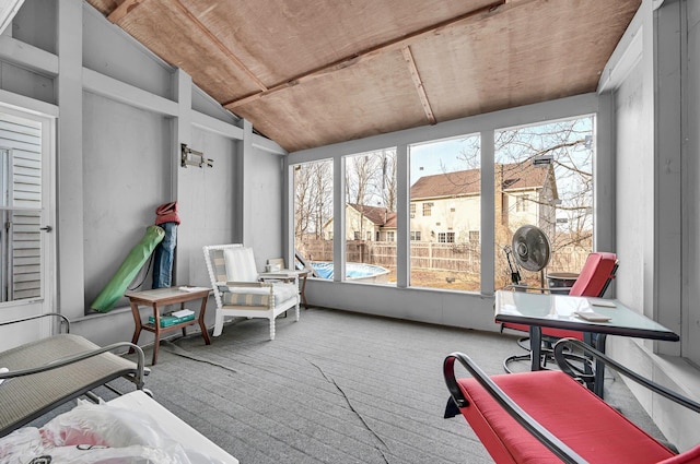 sunroom with lofted ceiling and a healthy amount of sunlight