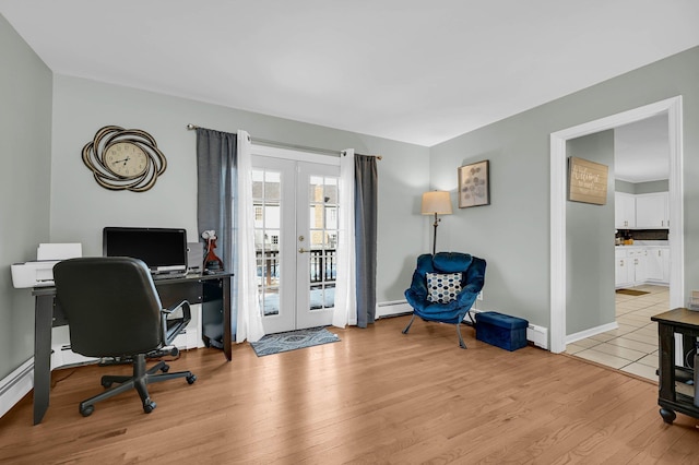 home office with french doors, a baseboard radiator, light wood-style flooring, and baseboards