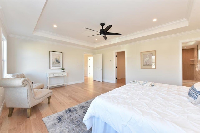 bedroom featuring crown molding, ceiling fan, a raised ceiling, and light hardwood / wood-style flooring