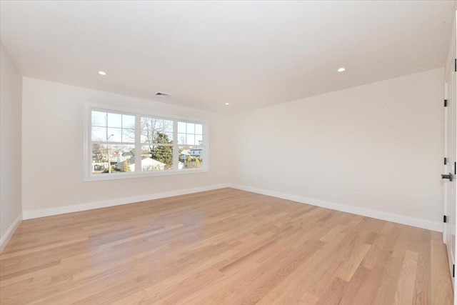 spare room with light hardwood / wood-style flooring