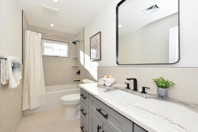 full bathroom with vanity, toilet, and shower / bath combo