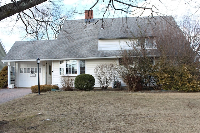 view of front of home with a garage and a front yard