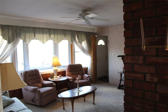 living room featuring a healthy amount of sunlight, ceiling fan, and carpet flooring