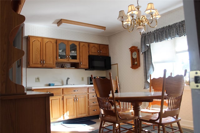 kitchen with sink, a chandelier, and decorative light fixtures