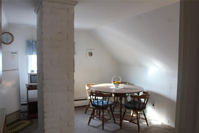 dining room featuring vaulted ceiling, baseboard heating, and carpet