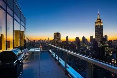 balcony at dusk with area for grilling