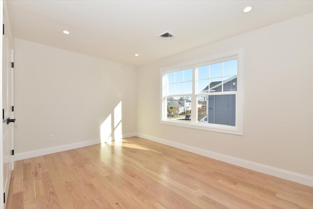 spare room with light hardwood / wood-style floors