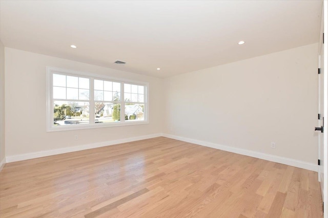 empty room with light hardwood / wood-style flooring