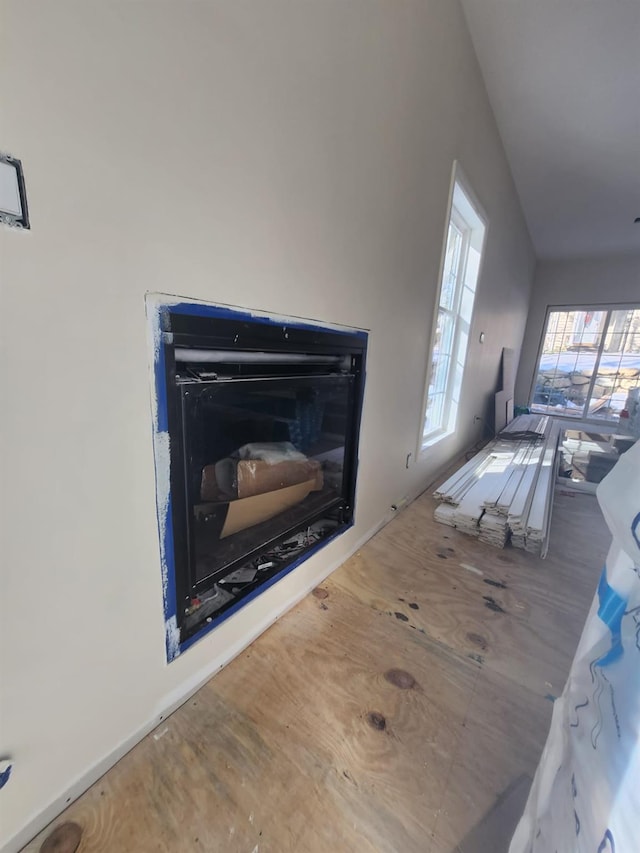 living room with a fireplace and wood finished floors