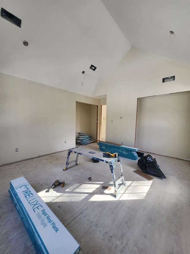 empty room featuring high vaulted ceiling