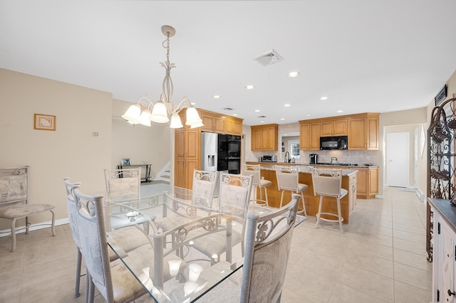 dining room featuring light tile patterned flooring and a chandelier