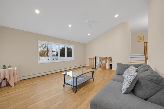 living room with lofted ceiling, light wood-type flooring, ceiling fan, and baseboard heating