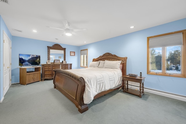 carpeted bedroom with ceiling fan and a baseboard radiator