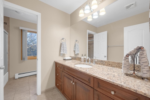 bathroom with baseboard heating, vanity, and tile patterned flooring