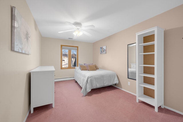 carpeted bedroom featuring a baseboard heating unit and ceiling fan