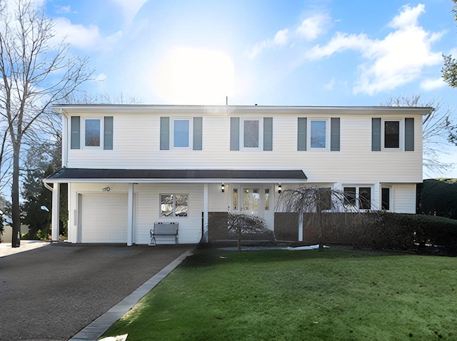 view of front of property featuring a garage and a front lawn