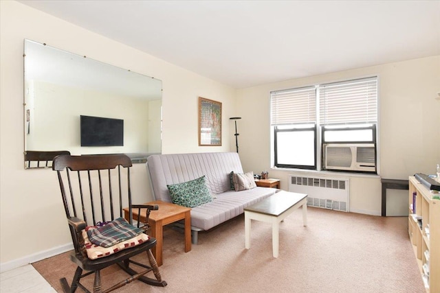 living area with baseboards, cooling unit, and radiator