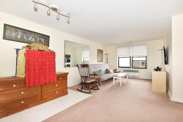 living area with radiator heating unit, carpet, and a wealth of natural light