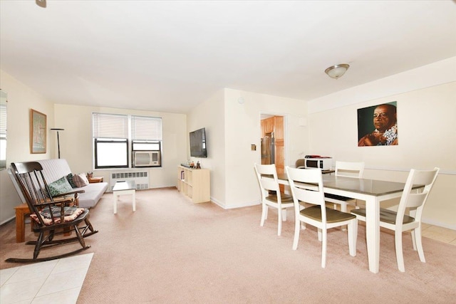 dining area with radiator, light carpet, and baseboards