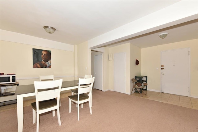 dining area featuring light carpet and light tile patterned floors