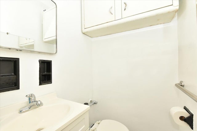 bathroom with toilet and vanity