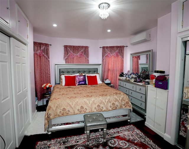 bedroom featuring a wall mounted air conditioner and a closet