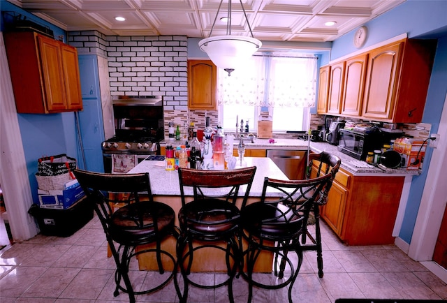 kitchen with light tile patterned floors, decorative light fixtures, stainless steel dishwasher, and a kitchen island