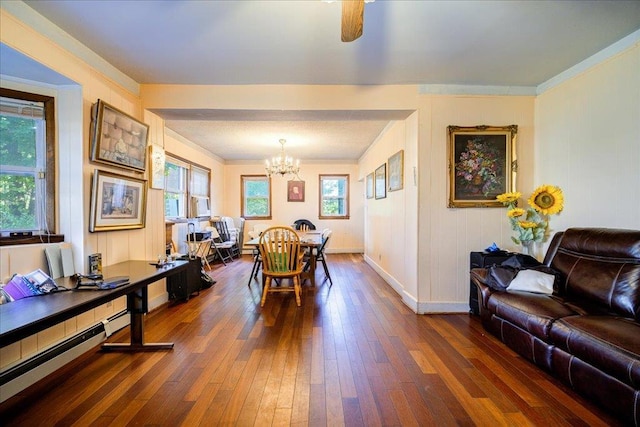 dining space with ornamental molding, dark wood-type flooring, and a chandelier