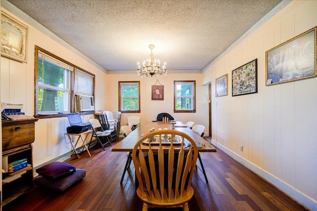 dining space featuring dark wood-type flooring, ornamental molding, a chandelier, and plenty of natural light