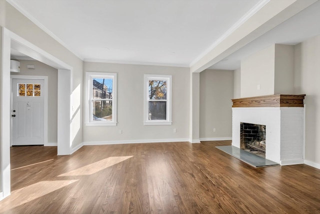 unfurnished living room featuring hardwood / wood-style floors and crown molding