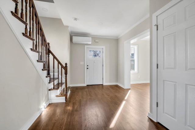 foyer entrance with crown molding, dark hardwood / wood-style flooring, and a wall mounted AC