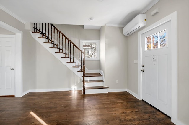 foyer with ornamental molding, dark wood-type flooring, and a wall mounted air conditioner