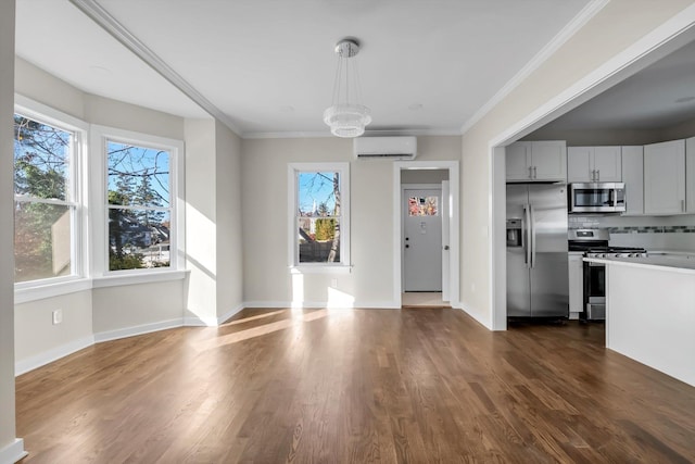 kitchen with tasteful backsplash, ornamental molding, dark hardwood / wood-style flooring, pendant lighting, and stainless steel appliances