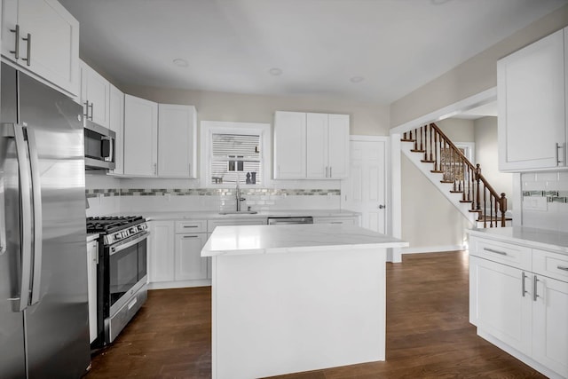 kitchen featuring white cabinetry, a center island, and appliances with stainless steel finishes