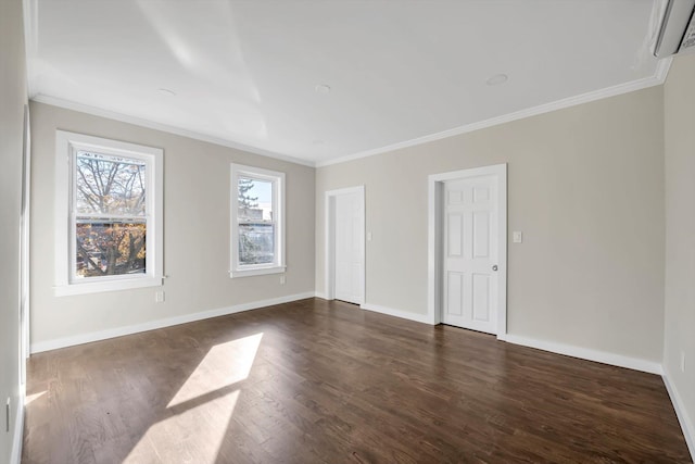 empty room featuring a wall mounted air conditioner, dark wood-type flooring, and ornamental molding