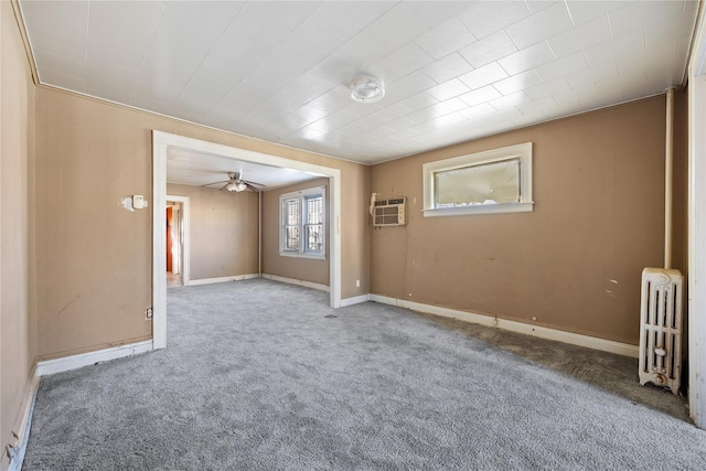 carpeted empty room with ceiling fan, radiator heating unit, and a wall mounted AC