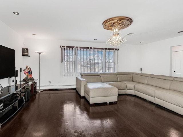 living room featuring an inviting chandelier, a baseboard heating unit, and dark hardwood / wood-style floors