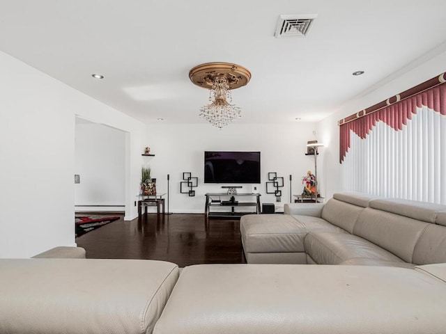 living room with an inviting chandelier, hardwood / wood-style flooring, and a baseboard radiator