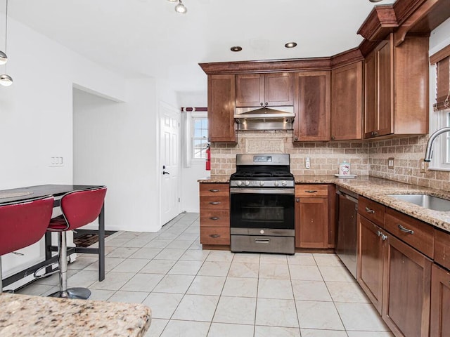 kitchen with light tile patterned flooring, sink, light stone counters, tasteful backsplash, and stainless steel appliances