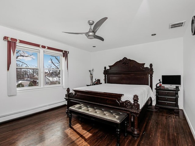 bedroom with a baseboard radiator, dark hardwood / wood-style floors, and ceiling fan