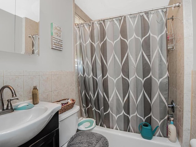 full bathroom featuring vanity, tile walls, shower / tub combo, and toilet