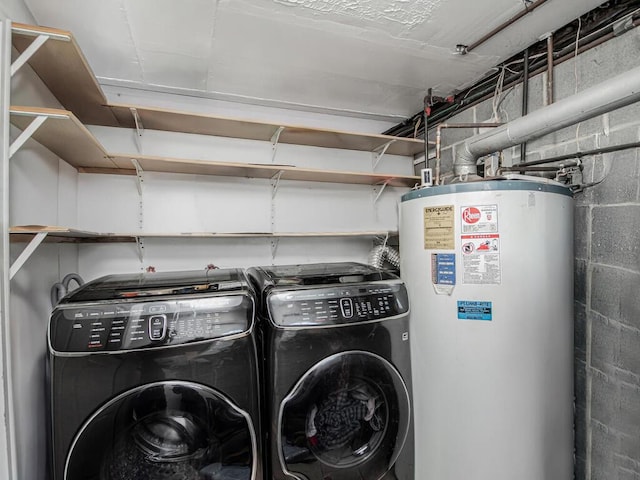 laundry area with gas water heater and independent washer and dryer