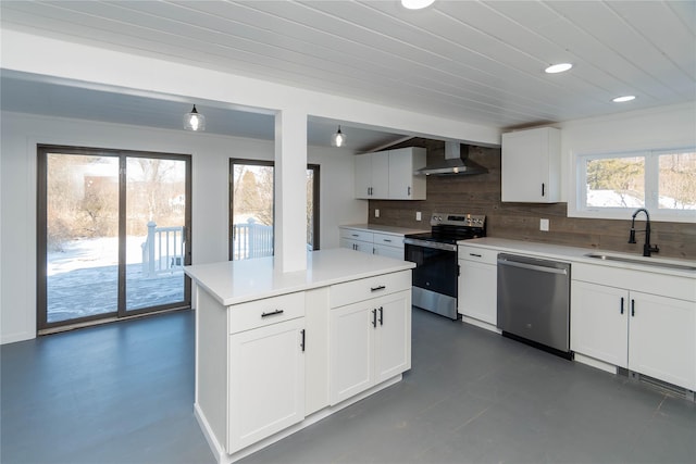 kitchen with sink, appliances with stainless steel finishes, white cabinetry, tasteful backsplash, and wall chimney exhaust hood