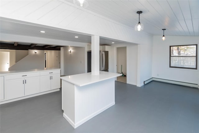 kitchen featuring pendant lighting, white cabinetry, lofted ceiling, stainless steel fridge, and baseboard heating